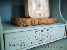 two books stacked on top of each other with a clock in the background and text reading rucosa roses