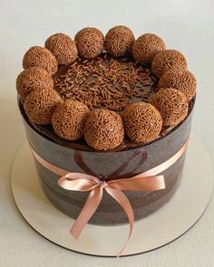 a cake with chocolate frosting and balls on top