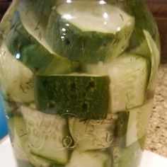 cucumber slices are arranged in a glass jar