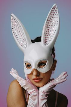 a woman wearing a bunny mask and gloves