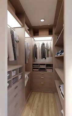 a walk - in closet with wooden flooring and drawers