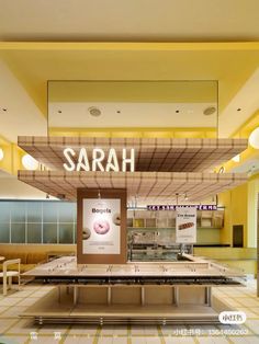 the interior of a food court with seating and signs on the wall that read, sahara