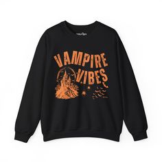 Sink your teeth into Halloween fashion with the Eddy and Rita Women's Heavy Crewneck Sweatshirt featuring the phrase "Vampire Vibes" in a spooky, stylish design. This heavyweight sweatshirt provides maximum warmth and comfort, making it perfect for those crisp autumn nights. With its relaxed fit, this sweatshirt is ideal for layering over your favorite Halloween ensemble or wearing solo for a cozy night in. Whether you're hitting a Halloween party, trick-or-treating, or just enjoying the season, Black Halloween Punk Sweatshirt, Black Punk Style Halloween Sweatshirt, Halloween Streetwear Sweatshirt With Letter Print, Black Punk Sweatshirt For Halloween, Black Punk Style Sweatshirt For Halloween, Halloween Letter Print Sweatshirt For Streetwear, Punk Halloween Sweatshirt With Graphic Print, Punk Style Halloween Sweatshirt With Graphic Print, Black Grunge Sweatshirt For Halloween