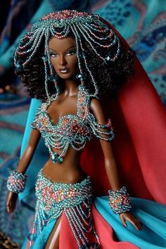 a barbie doll dressed up in a belly dance outfit and headpiece with jewels on it