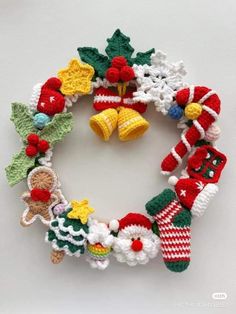 a crocheted christmas wreath with bells and decorations