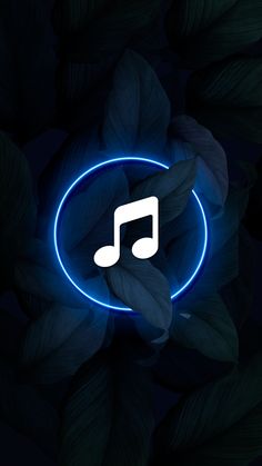 an illuminated music note in the center of a circle with leaves surrounding it and dark background