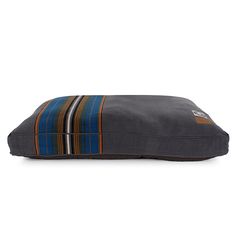 a dog bed with a striped design on the front and back, in dark grey