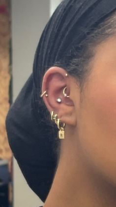 a close up of a person with ear piercings