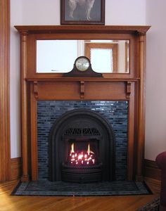 a fire place in a living room with a clock on top