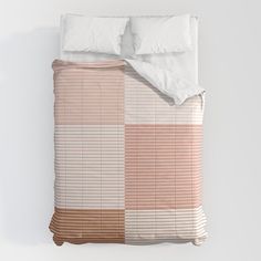 a bed with two pillows on top of it next to a pillow case and blanket