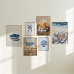 there are many paintings on the wall in this room, including pancakes and seashells