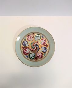 a white plate with multicolored designs on it