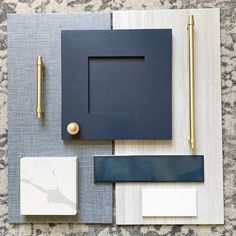 a table topped with blue and white tile next to a gold pen on top of it