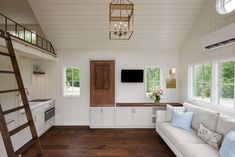 a living room filled with furniture and a ladder