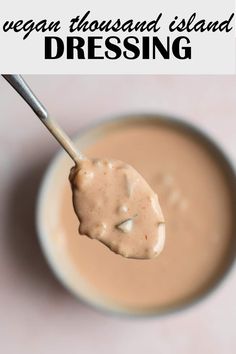 a spoon full of dressing with the words vegan thousand island dressing on it's side