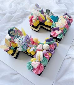 the letter e made out of cupcakes is decorated with flowers and other things