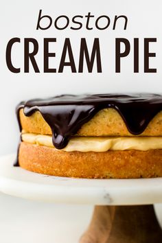 a close up of a cake on a plate with the words boston cream pie above it