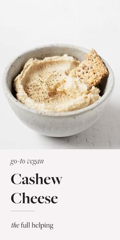 a white bowl filled with food on top of a table