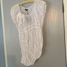 a white shirt hanging on the wall next to a door