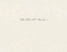 the word amore written in cursive handwriting on a white paper background with black ink