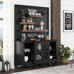 a black cabinet with shelves filled with coffee cups and other items on top of it