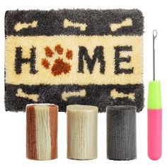 the rug has three different colored yarns in front of it and one with a dog's paw on it