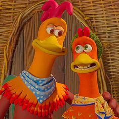 two cartoon characters standing next to each other in front of a wooden wall and wicker fence