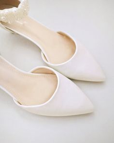 Ivory Satin Pointy Toe Low Heels with Perla Ankle Strap, Bridal Shoes Elegant Pearl Ankle Strap Wedding Shoes, Elegant Pearl Wedding Shoes With Ankle Strap, Elegant Formal Pointed Toe Flats With Ankle Strap, Elegant White Pointed Toe Flats With Low Heel, Elegant Flat Heel Bridesmaid Wedding Shoes, Elegant Flat Heel Wedding Shoes For Bridal Shower, Elegant Closed Toe Bridal Accessories For Bridesmaid, Pearl Wedding Shoes With Pointed Toe, Elegant Bridesmaid Pointed Toe Flats