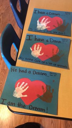 two children's handprints are placed on the table