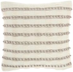 a white and grey striped pillow with fringes on the front, along with a black stripe