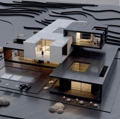 an architectural model of a modern house on top of a building with mountains in the background