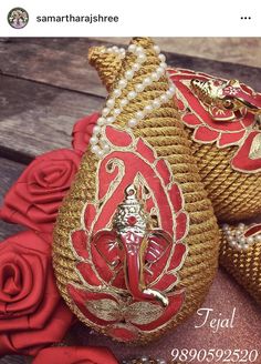 red and gold decorative items sitting on top of a wooden table next to roses with the caption that reads,