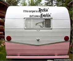 a pink and white camper parked in front of a building with the words rockin'don't come back on it