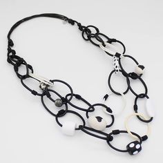 Rock this Black and White Casey Link Necklace for a playful and artistic touch to your outfit. The double strand leather chain link is accented with lightweight, resin hand-painted beads for an eye-catching statement. Never take yourself too seriously, have some fun! Adjustable length: 26"-32" Loops: .5" Care Instructions:Remove jewelry when applying perfumes, creams, washing hands, etc. Do not store in direct sunlight. To restore color and shine, apply a drop of oil with a soft cloth. Artsy White Everyday Jewelry, Trendy White Multi-strand Jewelry, White Resin Necklaces, Trendy Resin Chain Jewelry, Unique Black Necklace, Hand Painted Beads, Big Necklace, Bold Jewelry, Necklace Unique