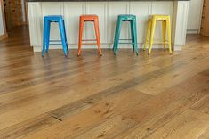 four stools are lined up in front of an island