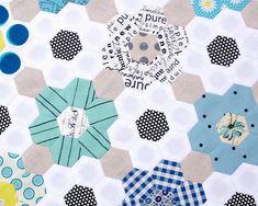 a patchwork quilt with blue, yellow and white hexagons on it