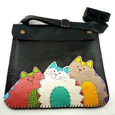 a black purse with three cats on it