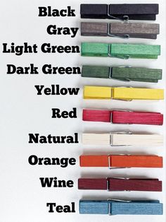 several colors of paper clips are lined up against a white background with the words black gray light green dark green yellow red natural orange wine