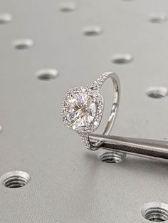 a diamond ring on top of a piece of metal