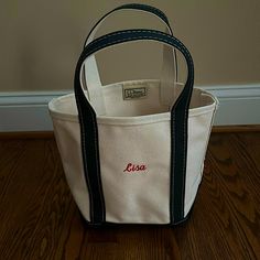 Brand New, Never Used, Perfect Condition! “Lisa” Is Embroidered In Red Thread. Canvas Is Ivory With Black Trim. Llbean Retails For $30 + $8 Monogramming + Shipping And Tax.Size Small Ll Bean Tote, Boat And Tote, Red Thread, Bean Bags, Small Canvas, Bean Bag, Ll Bean, Black Trim, L L Bean