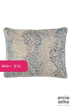 a blue and white pillow with a pink tag for $ 16 on the front side