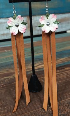 the earrings are made with leather and flowers