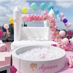 an inflatable pool surrounded by balloons and other decorations