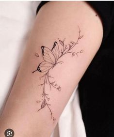 a woman's arm with a butterfly tattoo on the left side of her arm