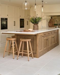 a kitchen island with two stools in front of it