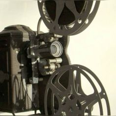 an old movie projector sitting on top of a table