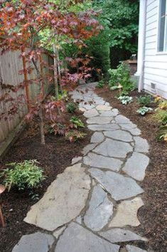 a stone path in front of a house