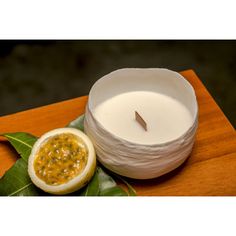 a white candle sitting on top of a wooden table