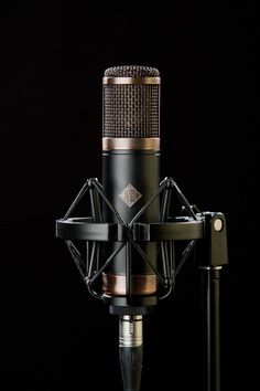 an old fashioned microphone is shown against a black background, with the top section exposed