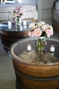 a table with flowers and candles on it in front of a glass top coffee table